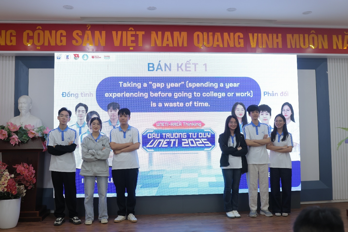 A group of people standing in front of a large screen AI-generated content may be incorrect.