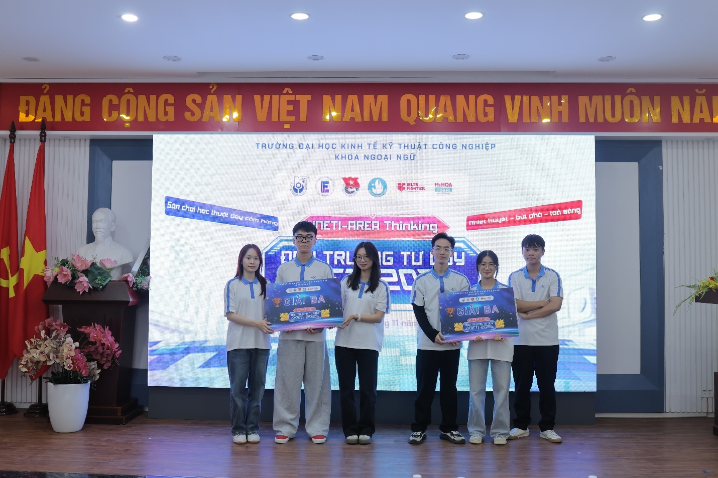 A group of people standing in front of a large screen AI-generated content may be incorrect.