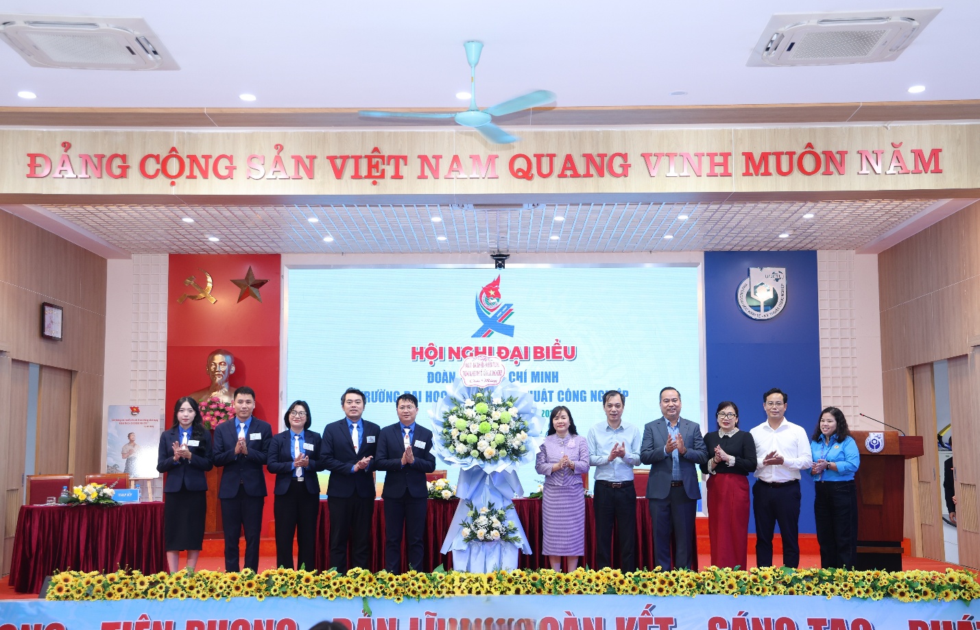 A group of people standing on a stage Description automatically generated