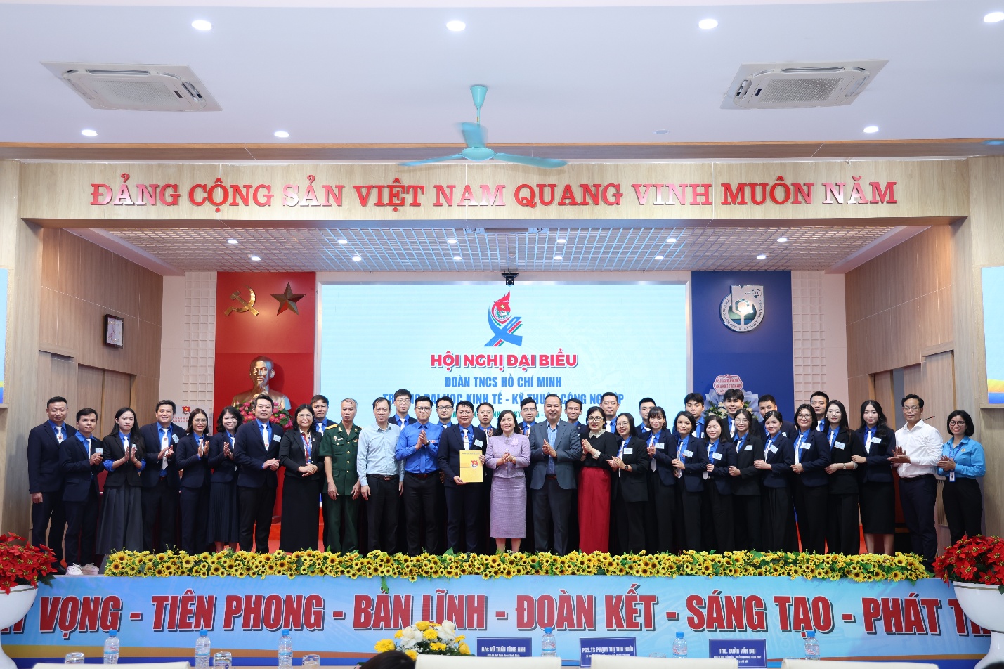 A group of people standing on a stage Description automatically generated