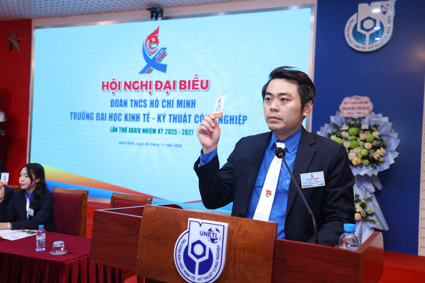 A person standing at a podium Description automatically generated