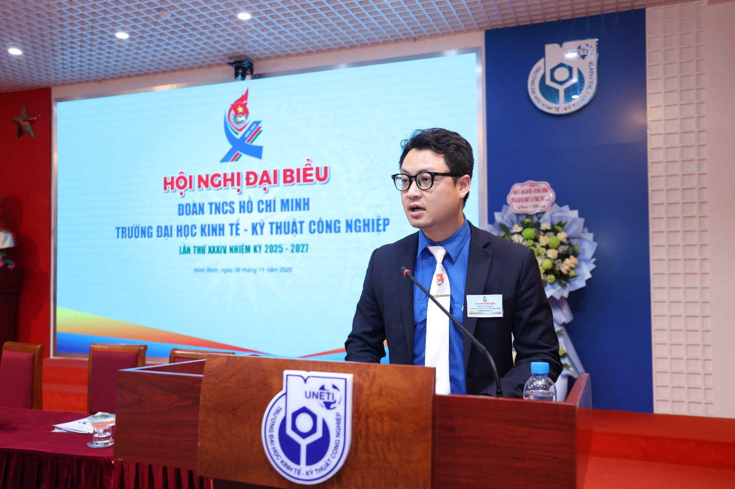 A person standing at a podium Description automatically generated