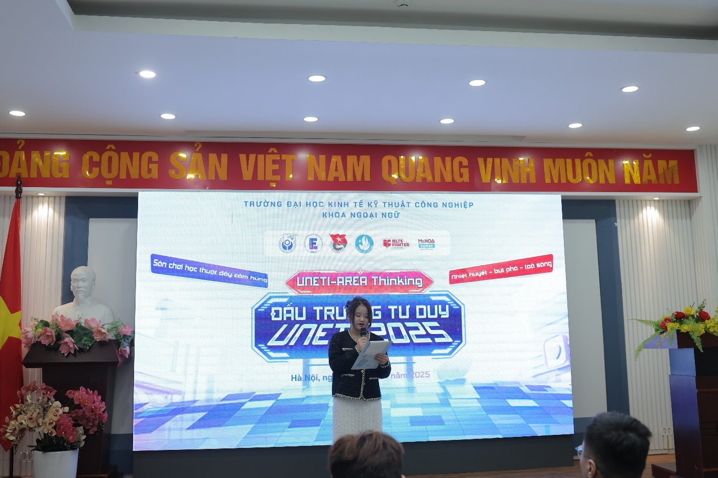 A person standing in front of a stage AI-generated content may be incorrect.