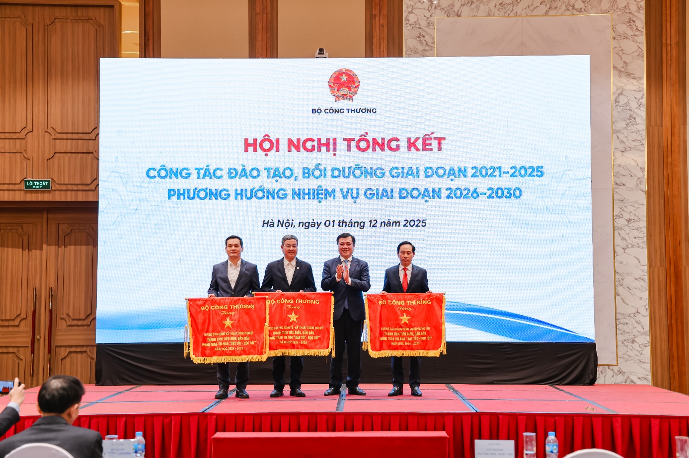 A group of men on a stage Description automatically generated