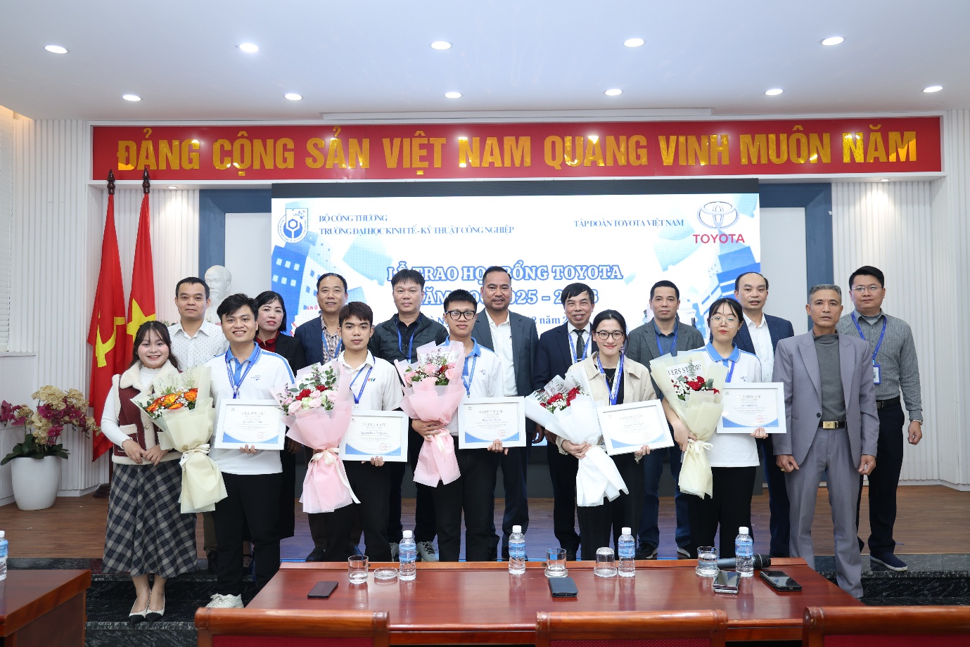 A group of people holding certificates Description automatically generated