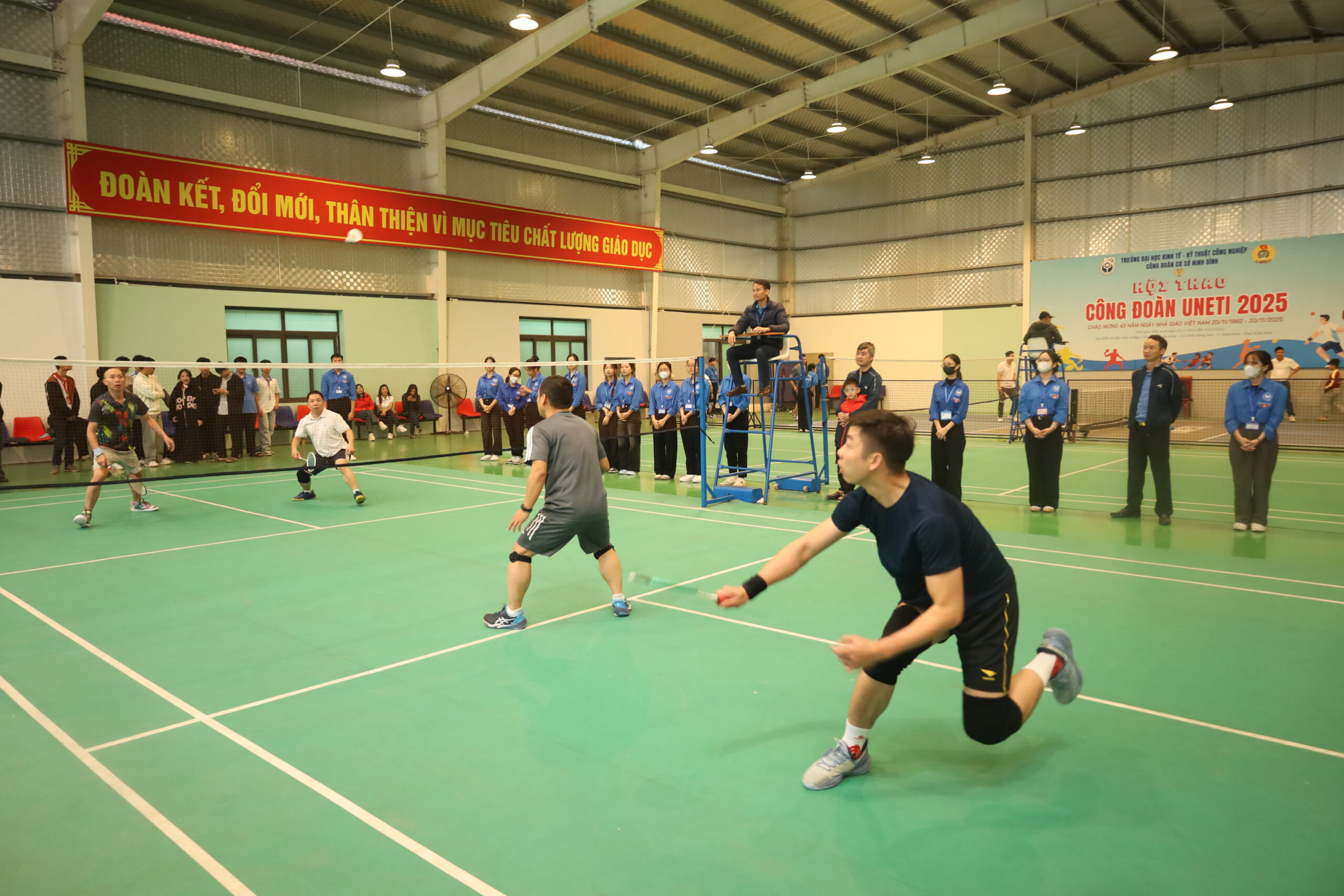 A group of people playing badminton

Description automatically generated