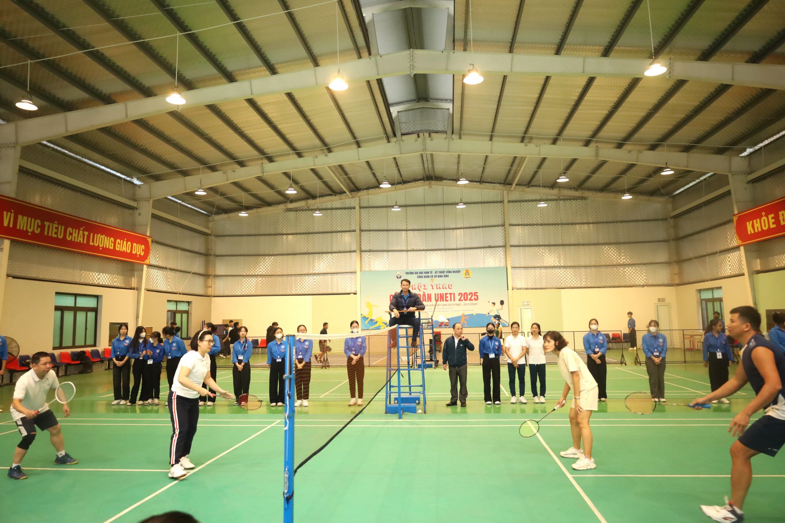 A group of people playing badminton

Description automatically generated