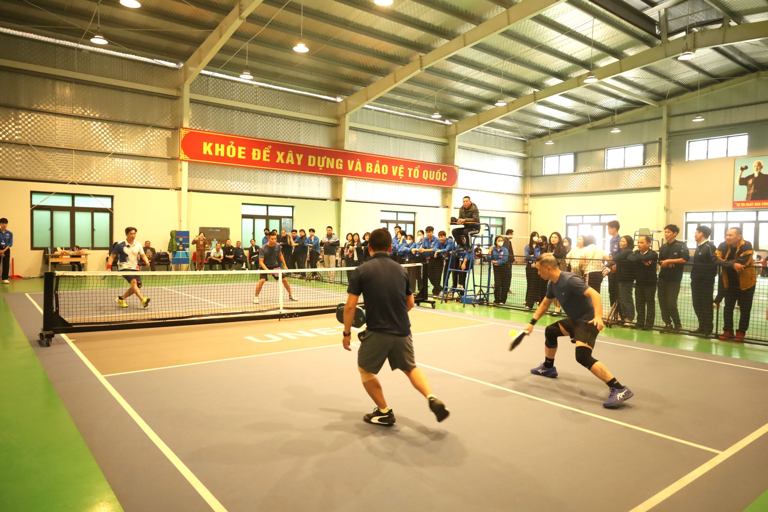 A group of people playing tennis

Description automatically generated