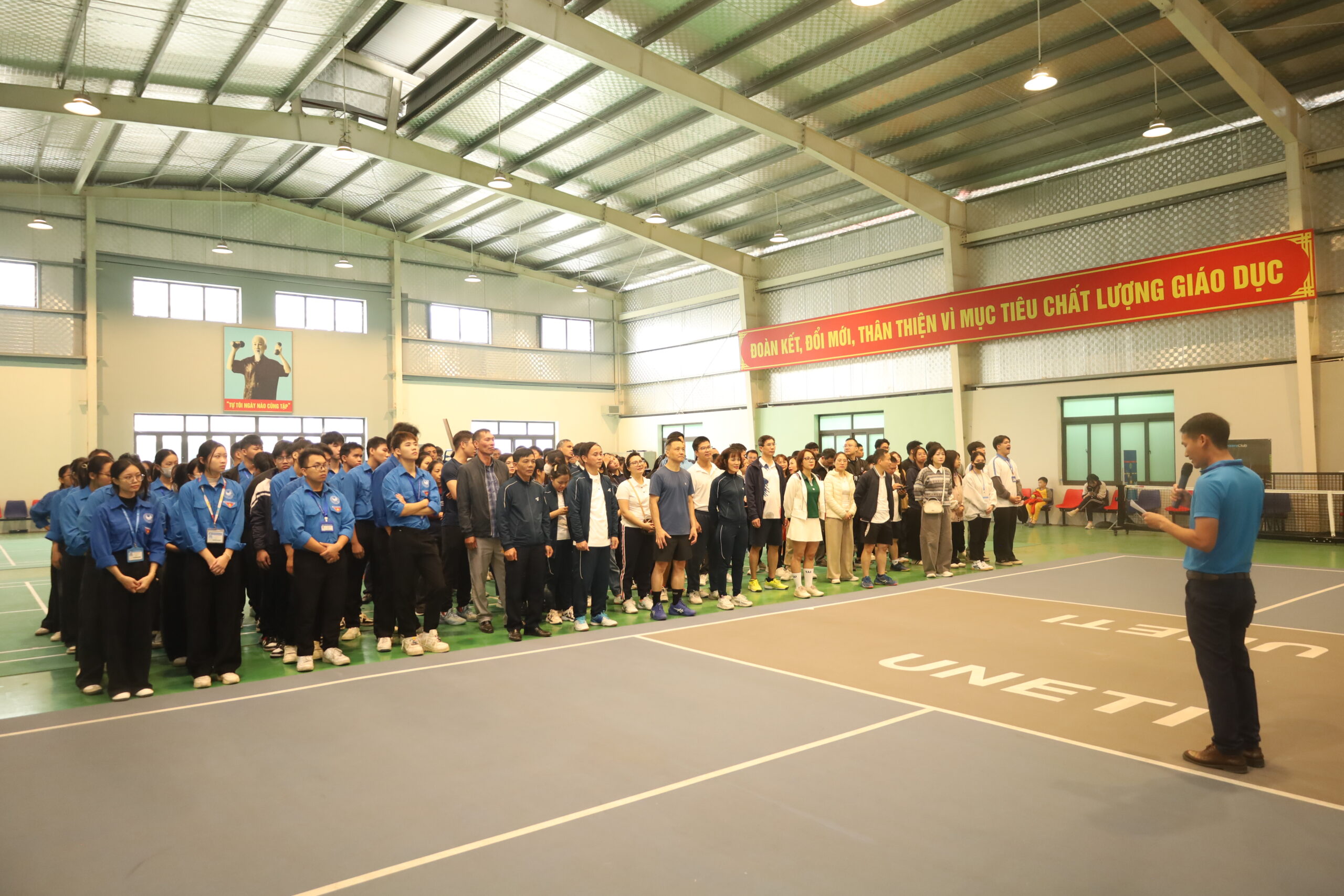 A group of people standing in a large room

Description automatically generated