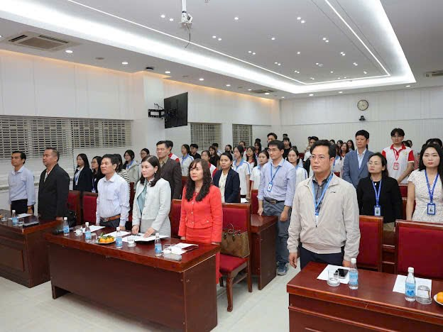 A group of people standing in a room Description automatically generated