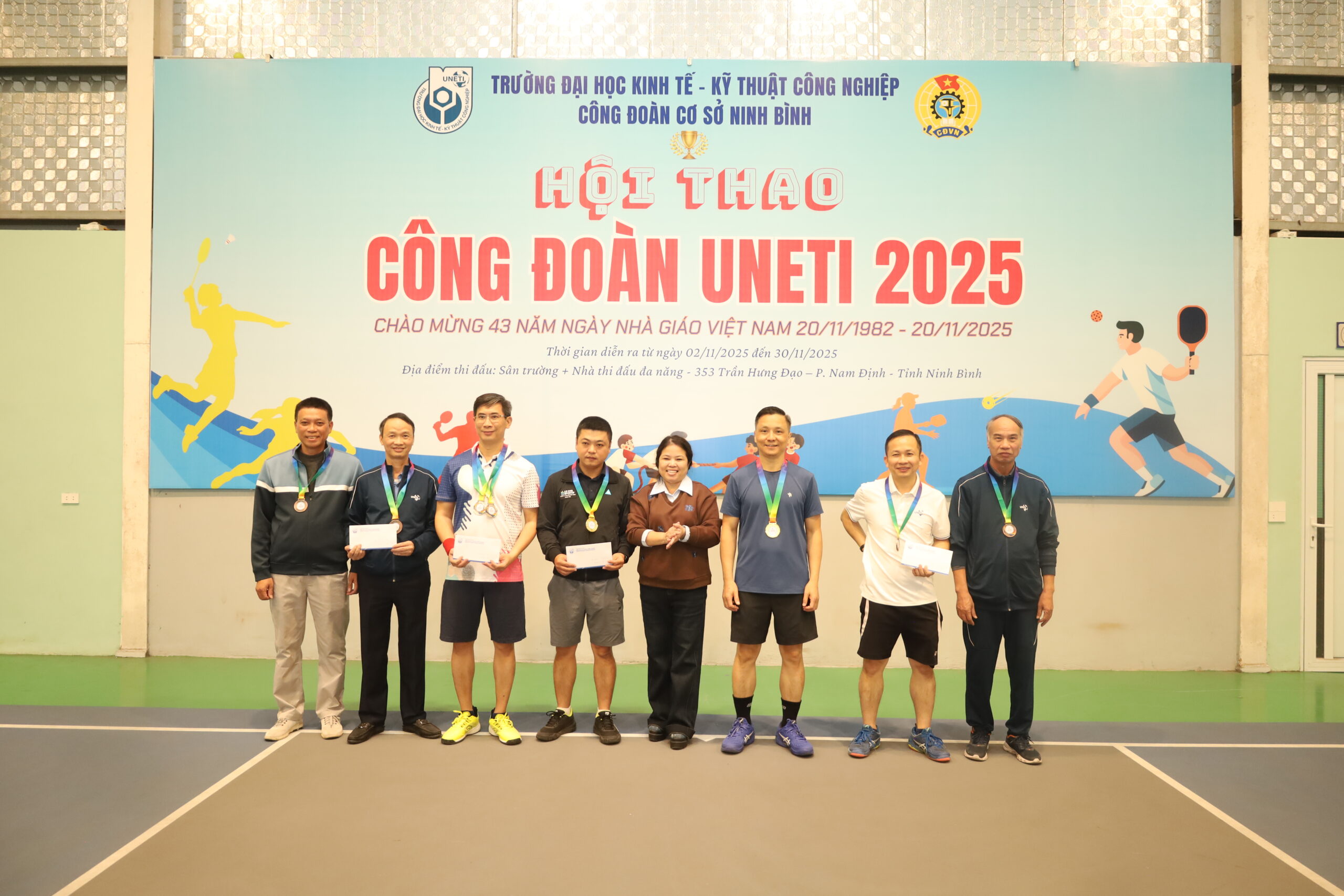 A group of people standing in front of a sign

Description automatically generated