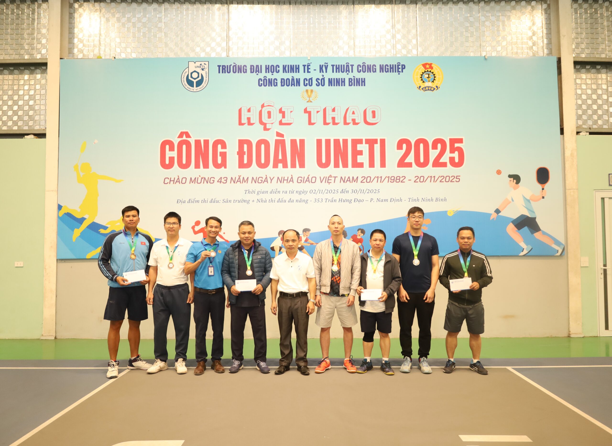 A group of people standing in front of a sign

Description automatically generated