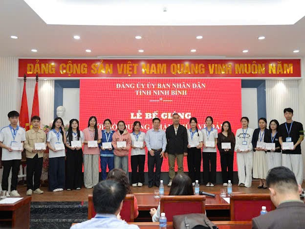 A group of people standing on a stage Description automatically generated