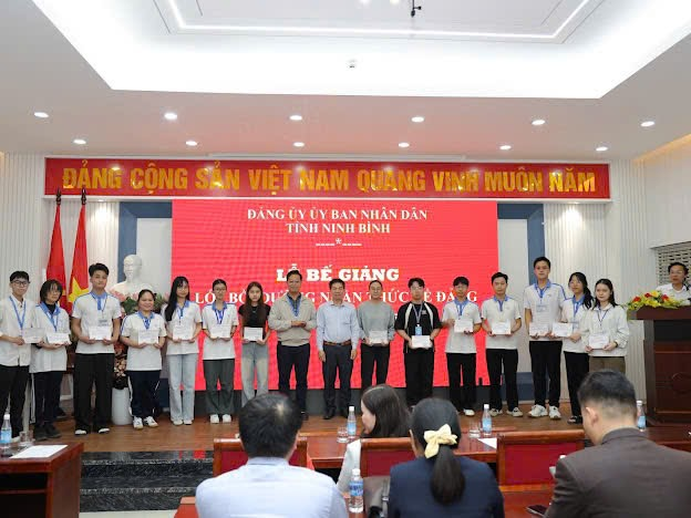 A group of people standing on a stage Description automatically generated