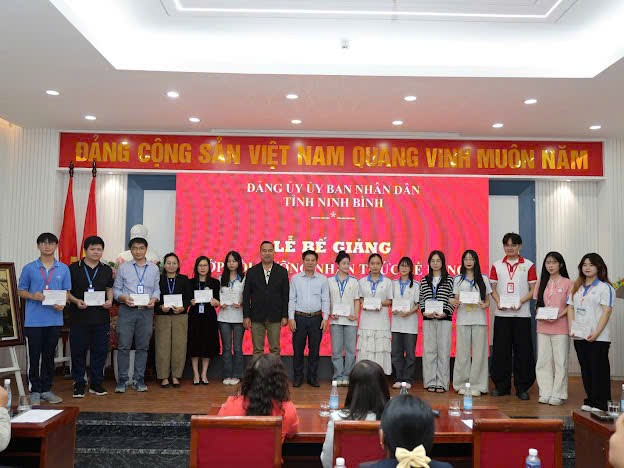 A group of people standing on a stage Description automatically generated