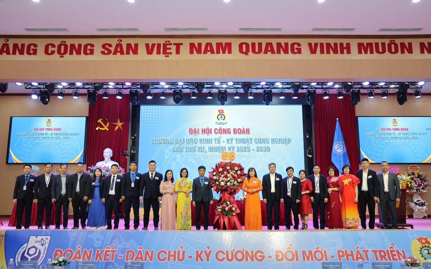 A group of people standing on a stage Description automatically generated