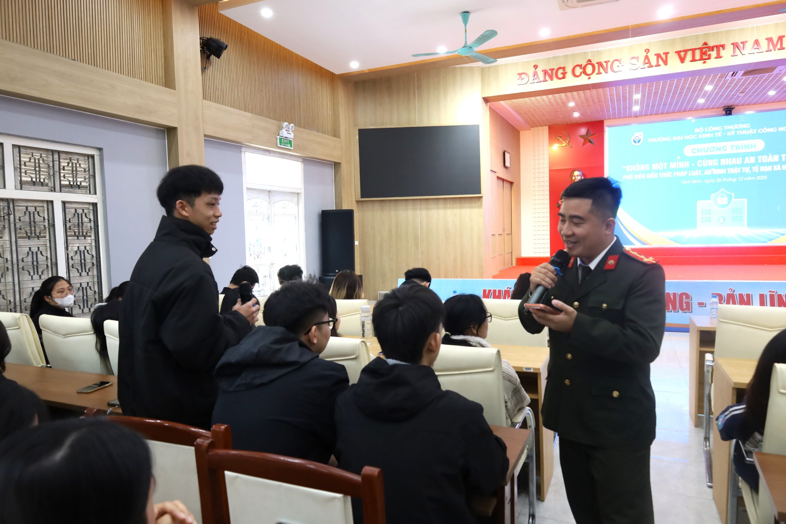 A person in uniform speaking to a group of people Description automatically generated