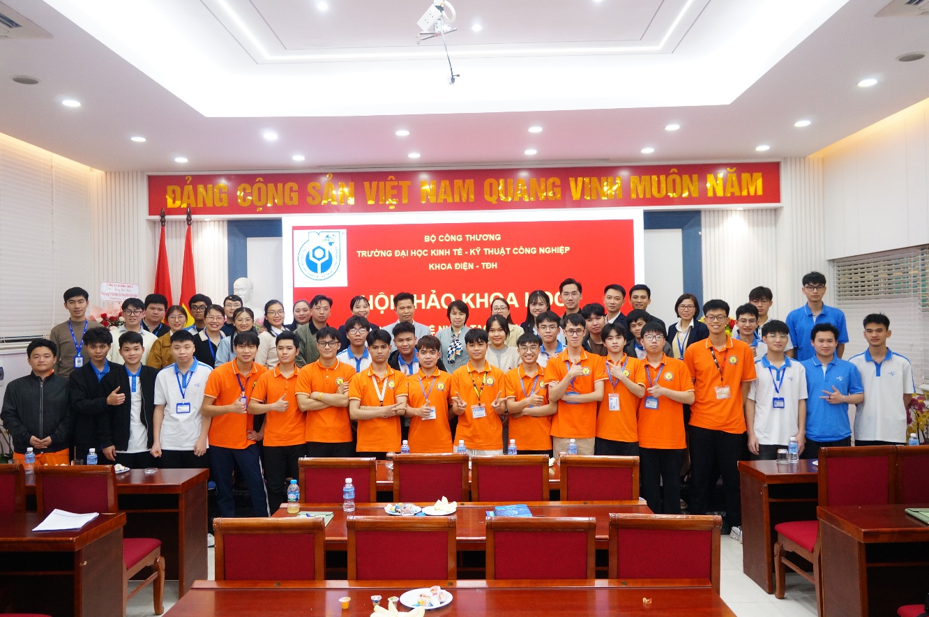A group of people in orange shirts Description automatically generated