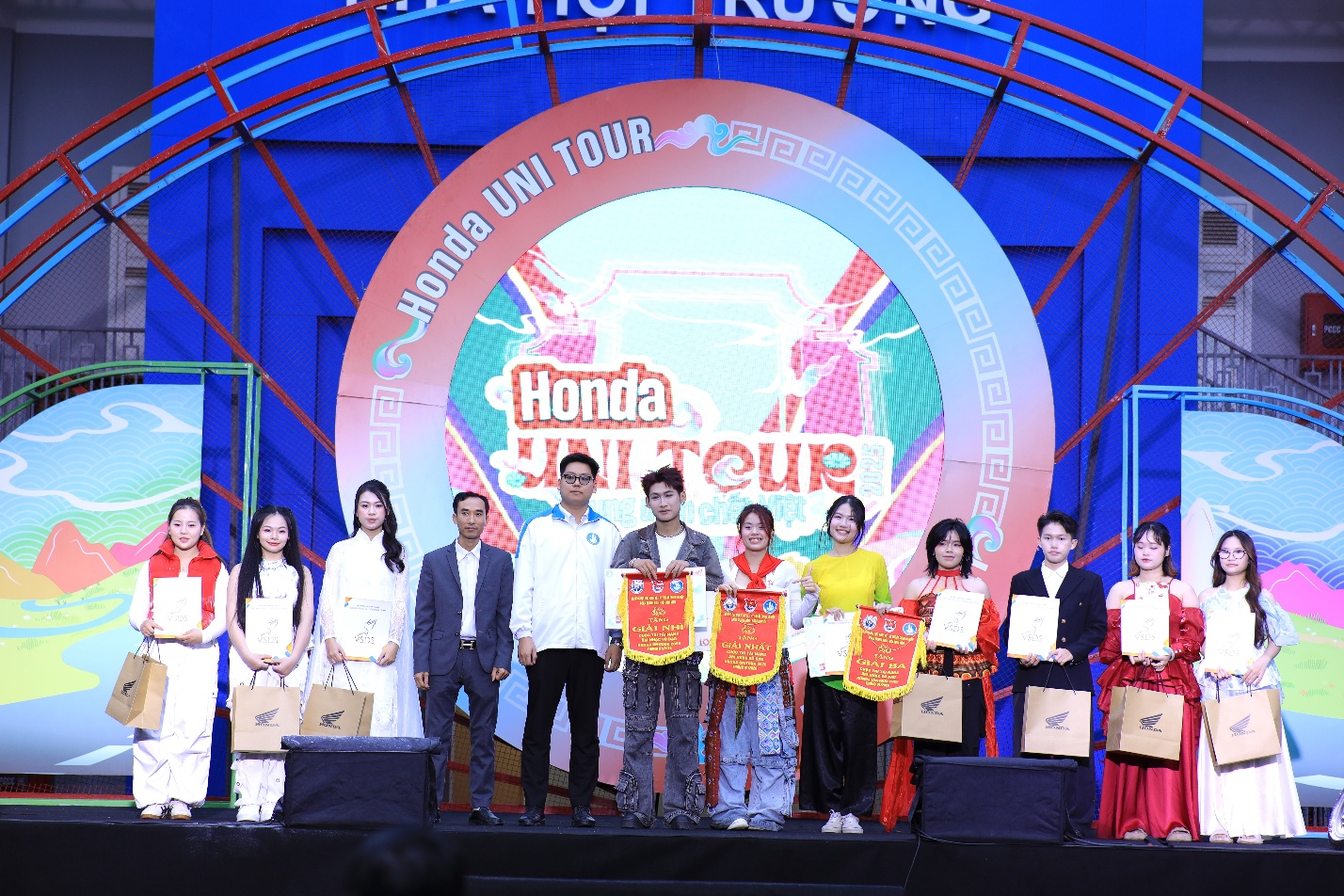 A group of people on a stage Description automatically generated