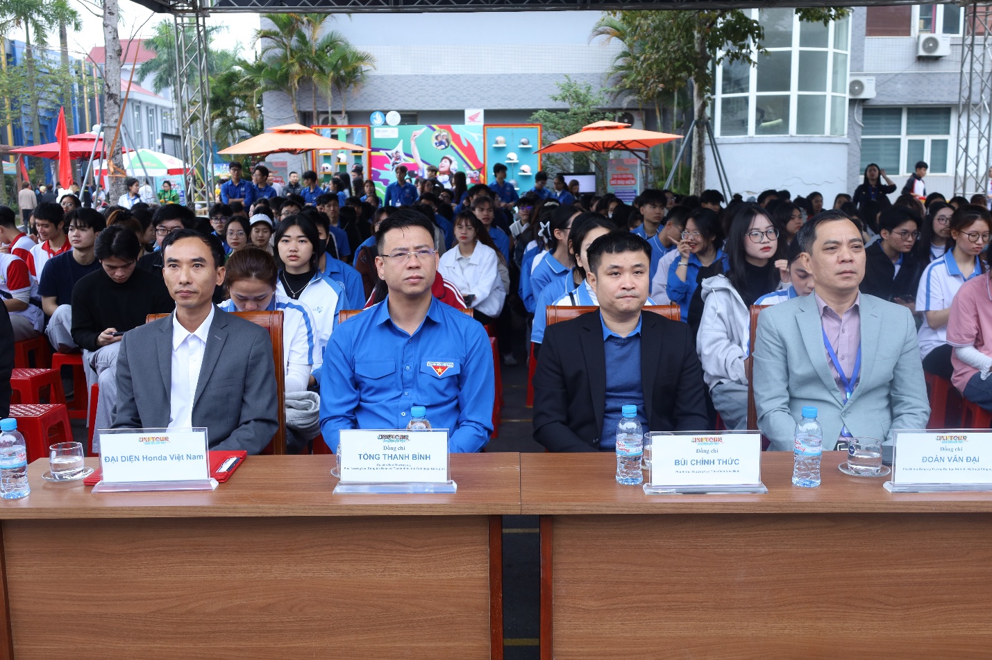 A group of people sitting at tables Description automatically generated