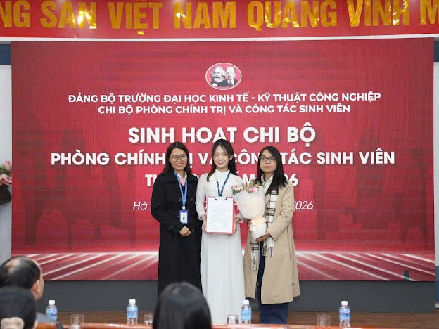 A group of women standing in front of a red banner
Description automatically generated