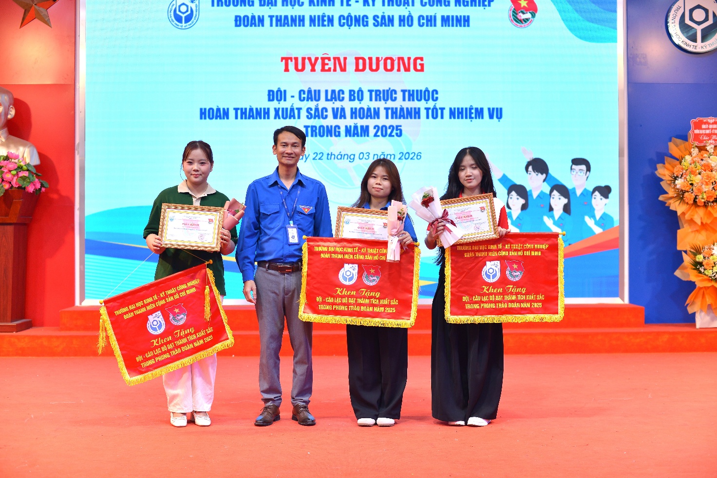 A group of people holding banners Description automatically generated