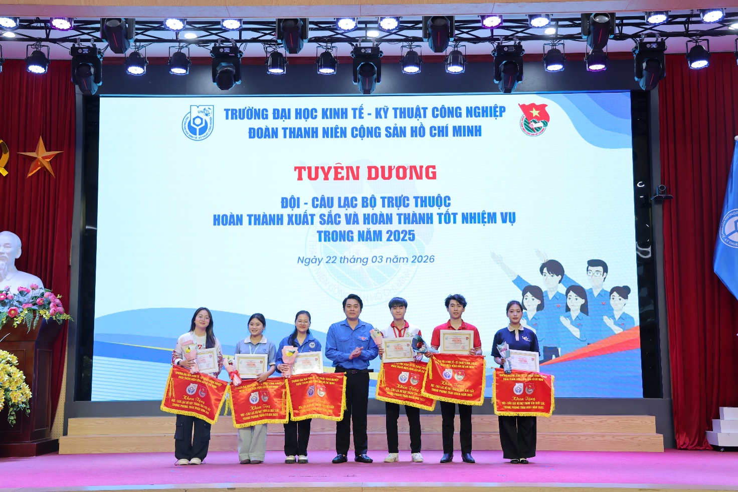 A group of people holding flags Description automatically generated