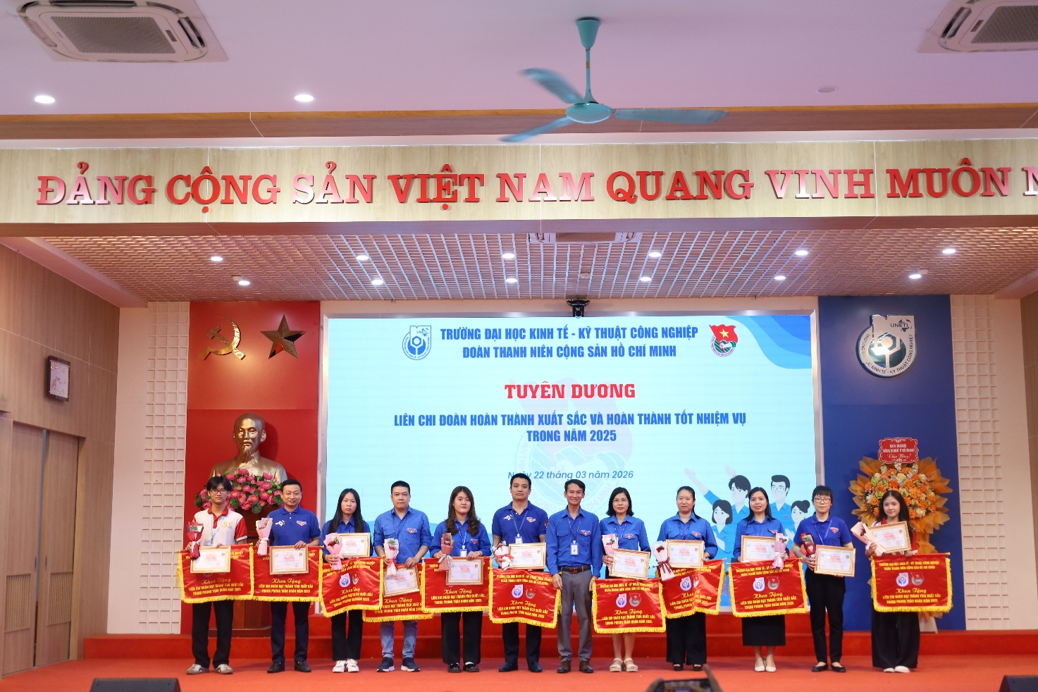 A group of people holding signs Description automatically generated