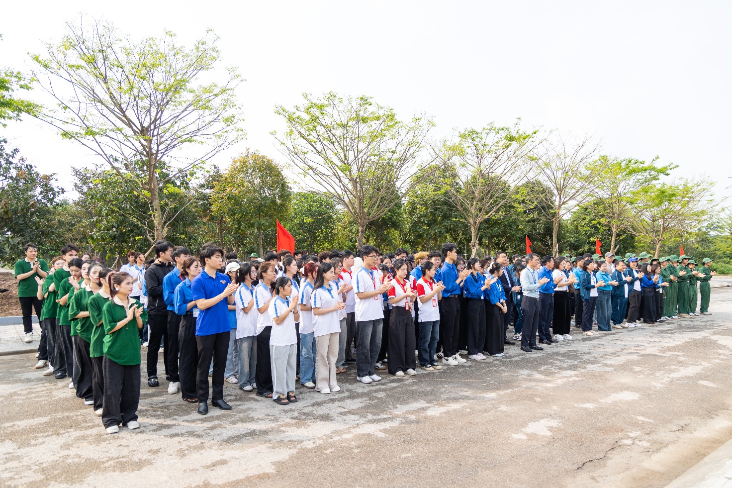 A group of people standing in a line Description automatically generated