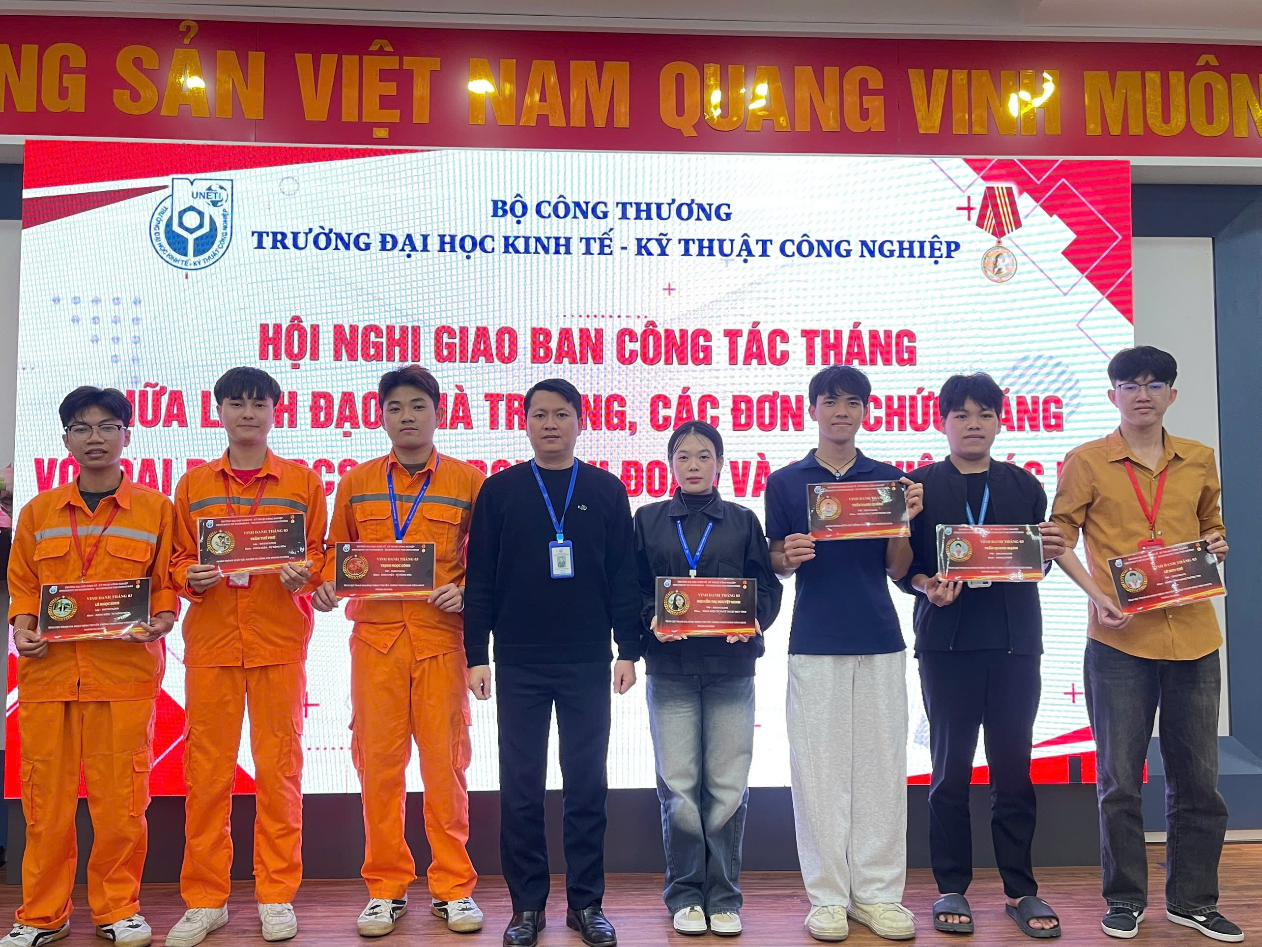A group of people standing together holding awards
Description automatically generated