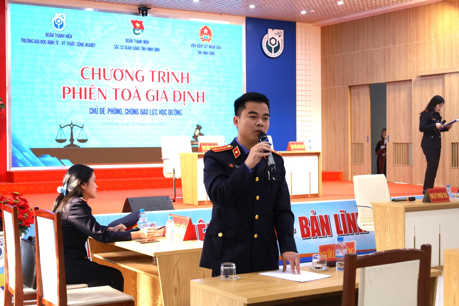 A person in a uniform speaking into a microphone Description automatically generated
