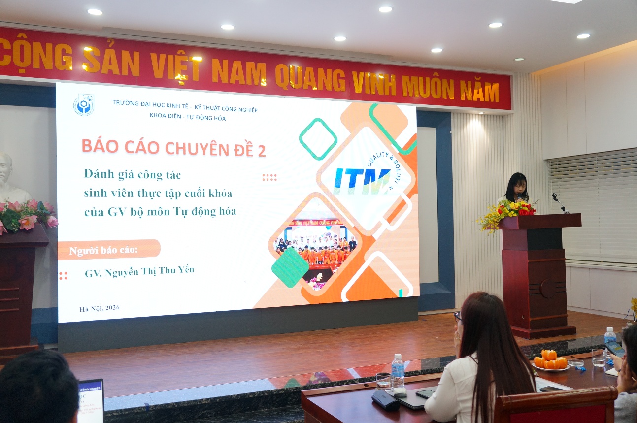 A person standing in front of a large screen
Description automatically generated