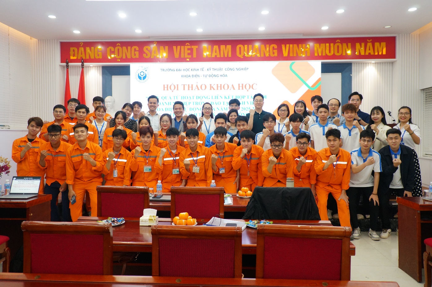 A group of people in orange uniforms Description automatically generated