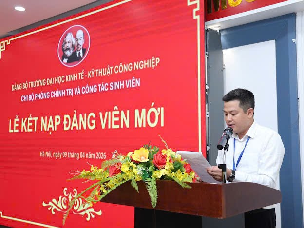 A person standing at a podium with a microphone
Description automatically generated