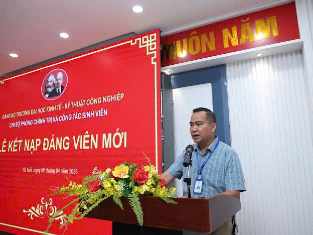 A person standing at a podium with a microphone
Description automatically generated
