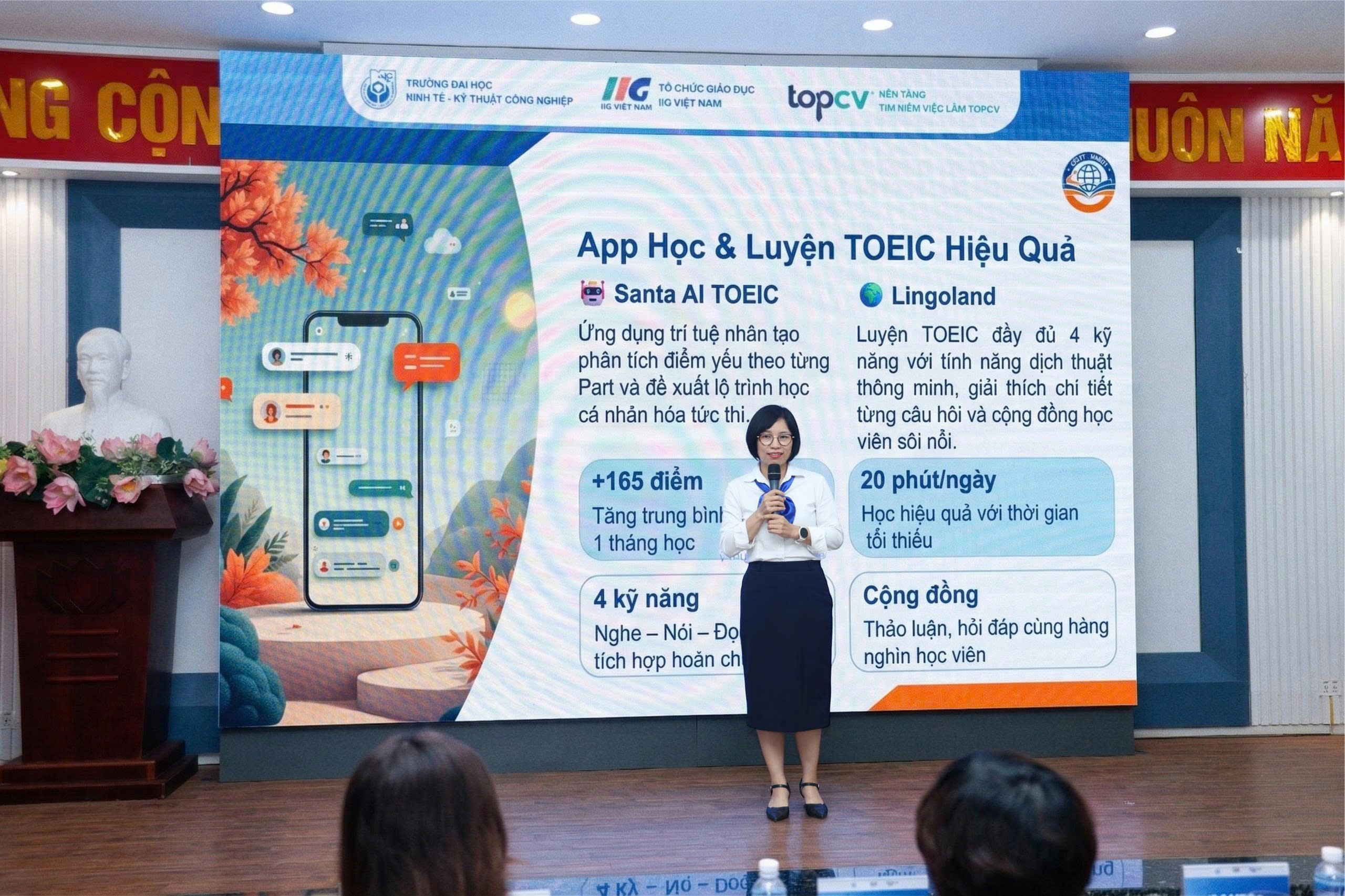 A person standing in front of a large banner Description automatically generated