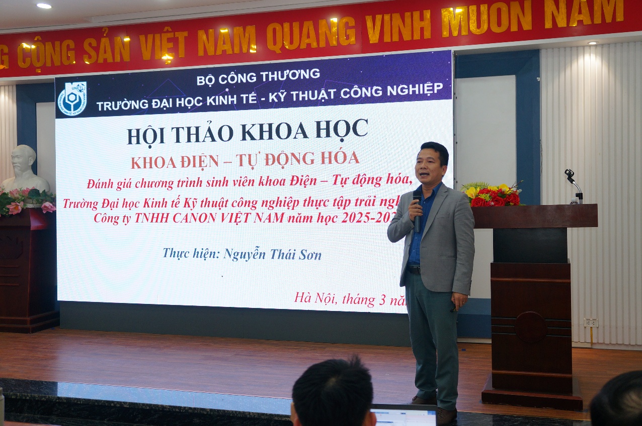 A person standing in front of a large screen Description automatically generated