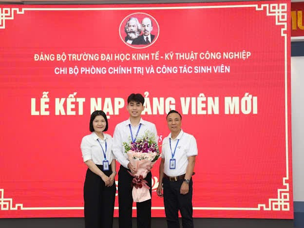 A group of people standing in front of a large sign
Description automatically generated