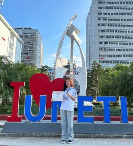 A person standing in front of a large sign

Description automatically generated