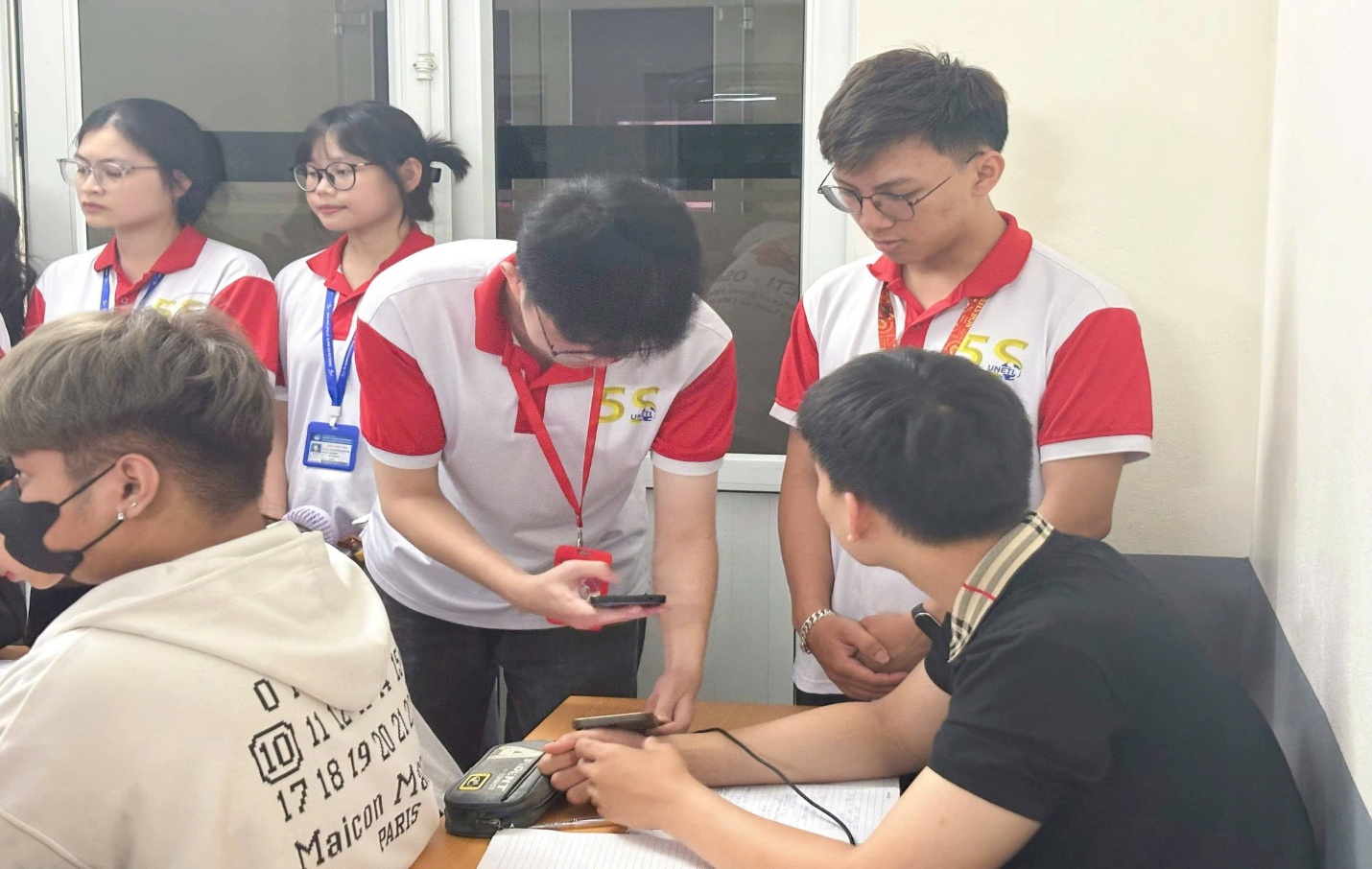 Có thể là hình ảnh về một hoặc nhiều người, mọi người đang học và văn bản