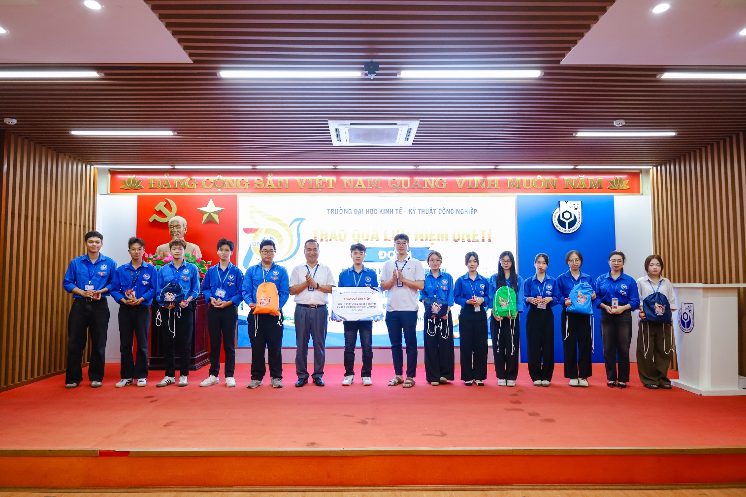 A group of people standing on a stage
Description automatically generated