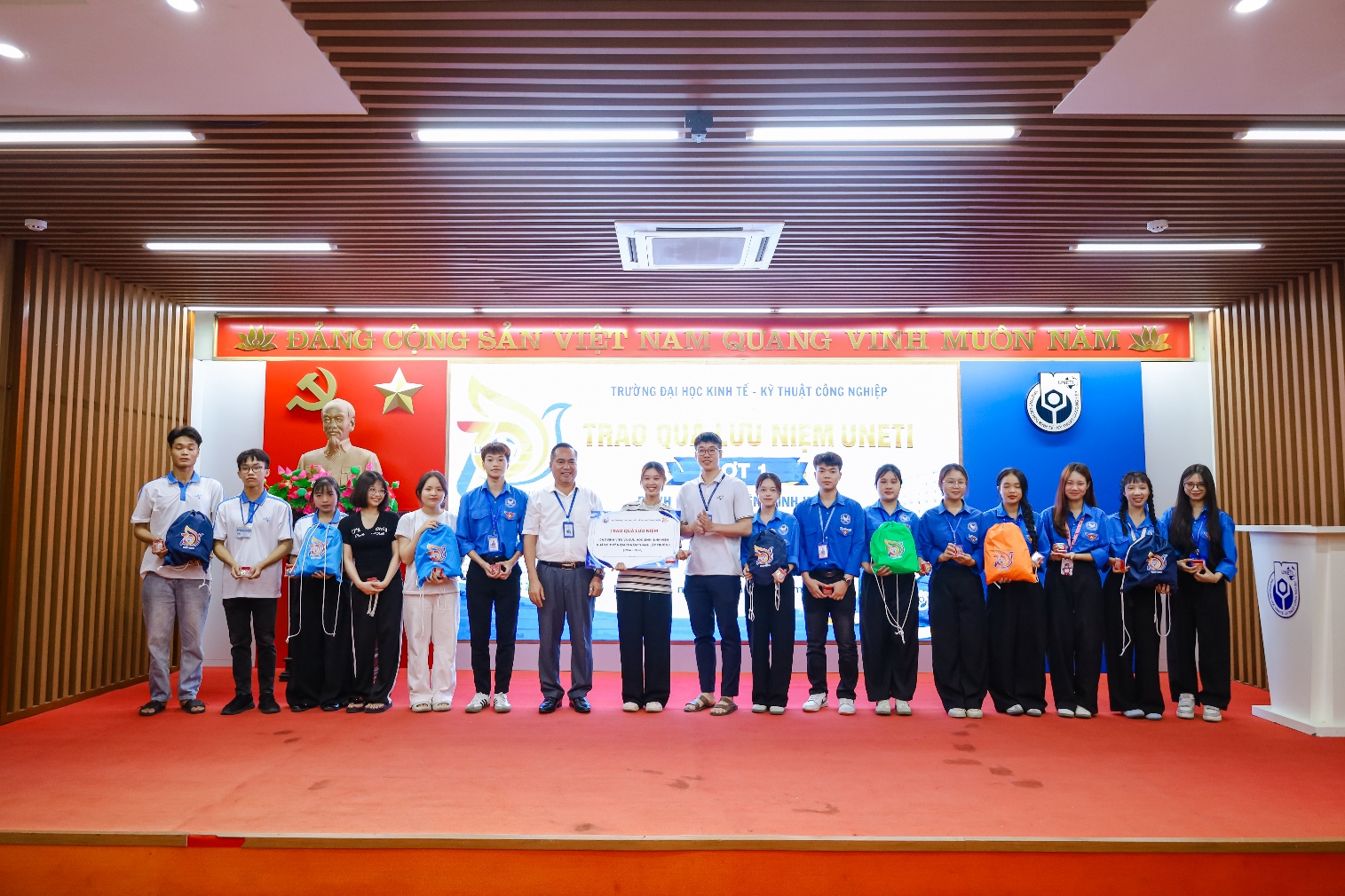 A group of people standing on a stage
Description automatically generated