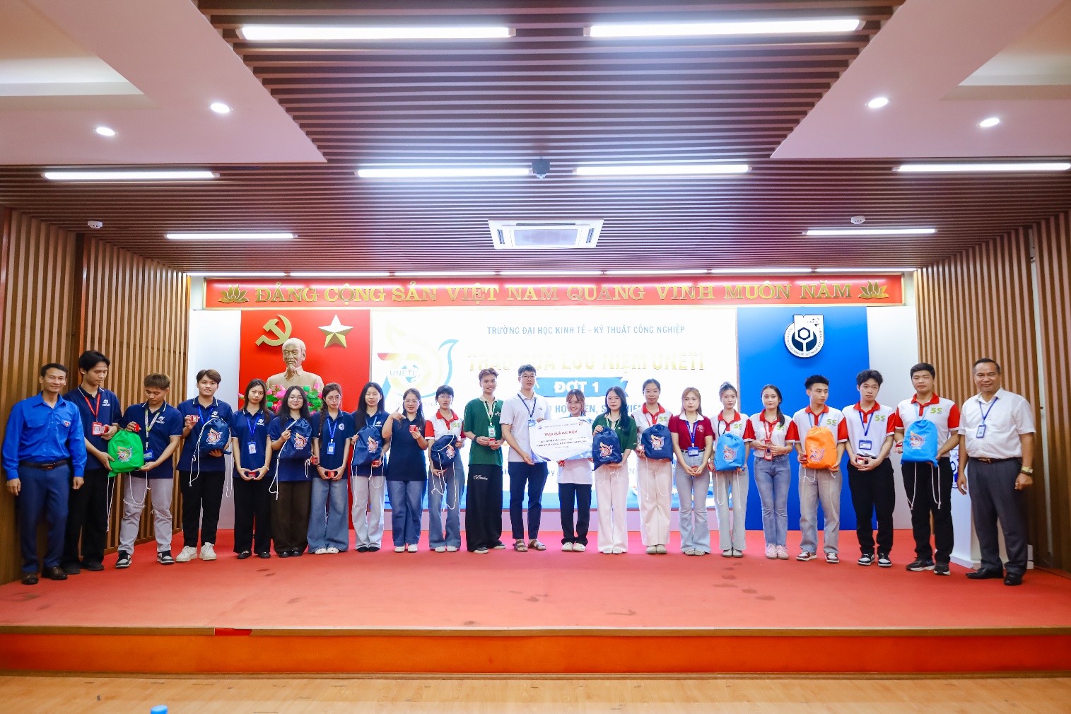 A group of people standing on a stage
Description automatically generated