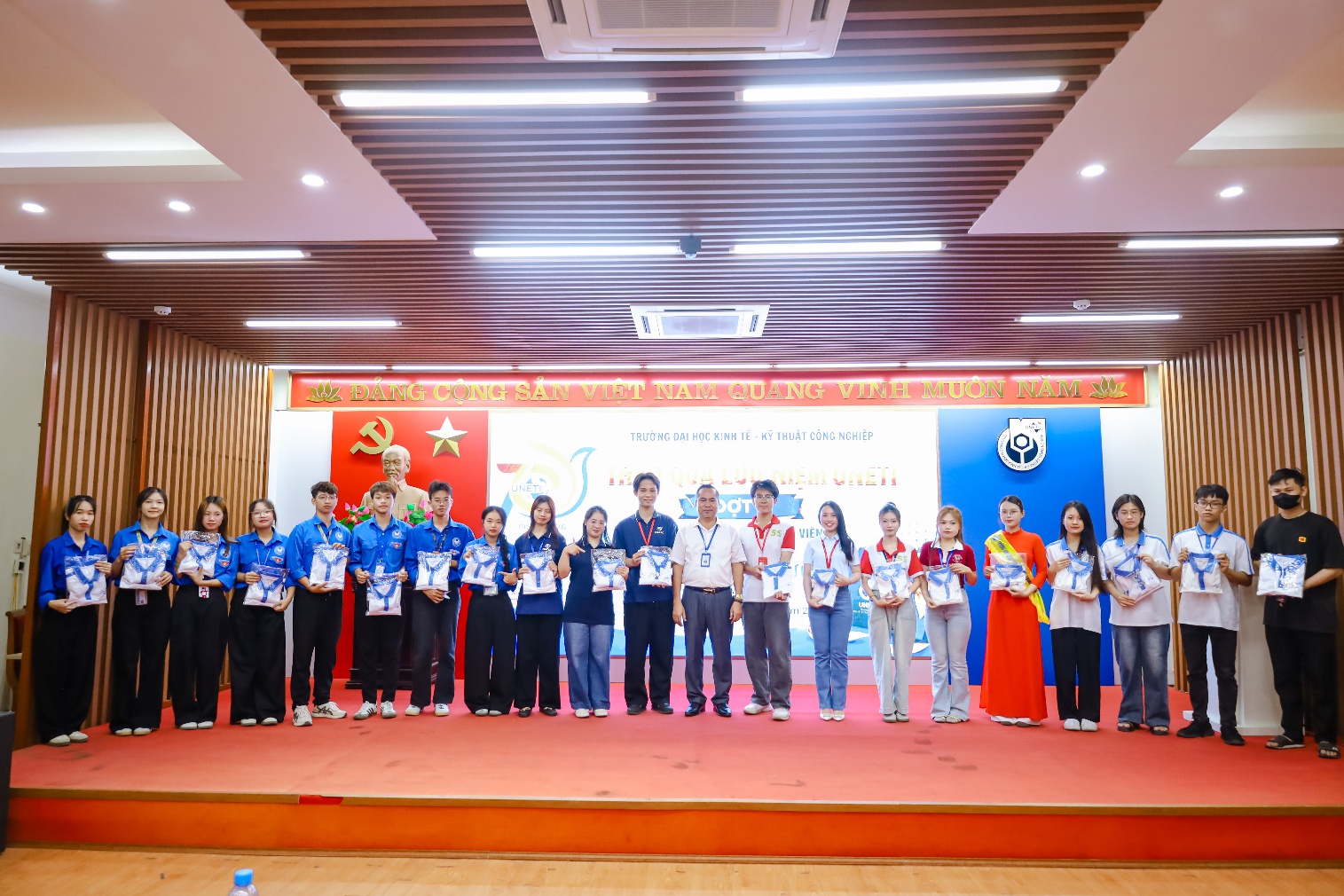 A group of people standing on a stage
Description automatically generated
