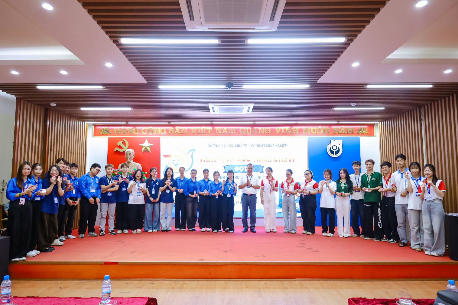 A group of people standing on a stage
Description automatically generated