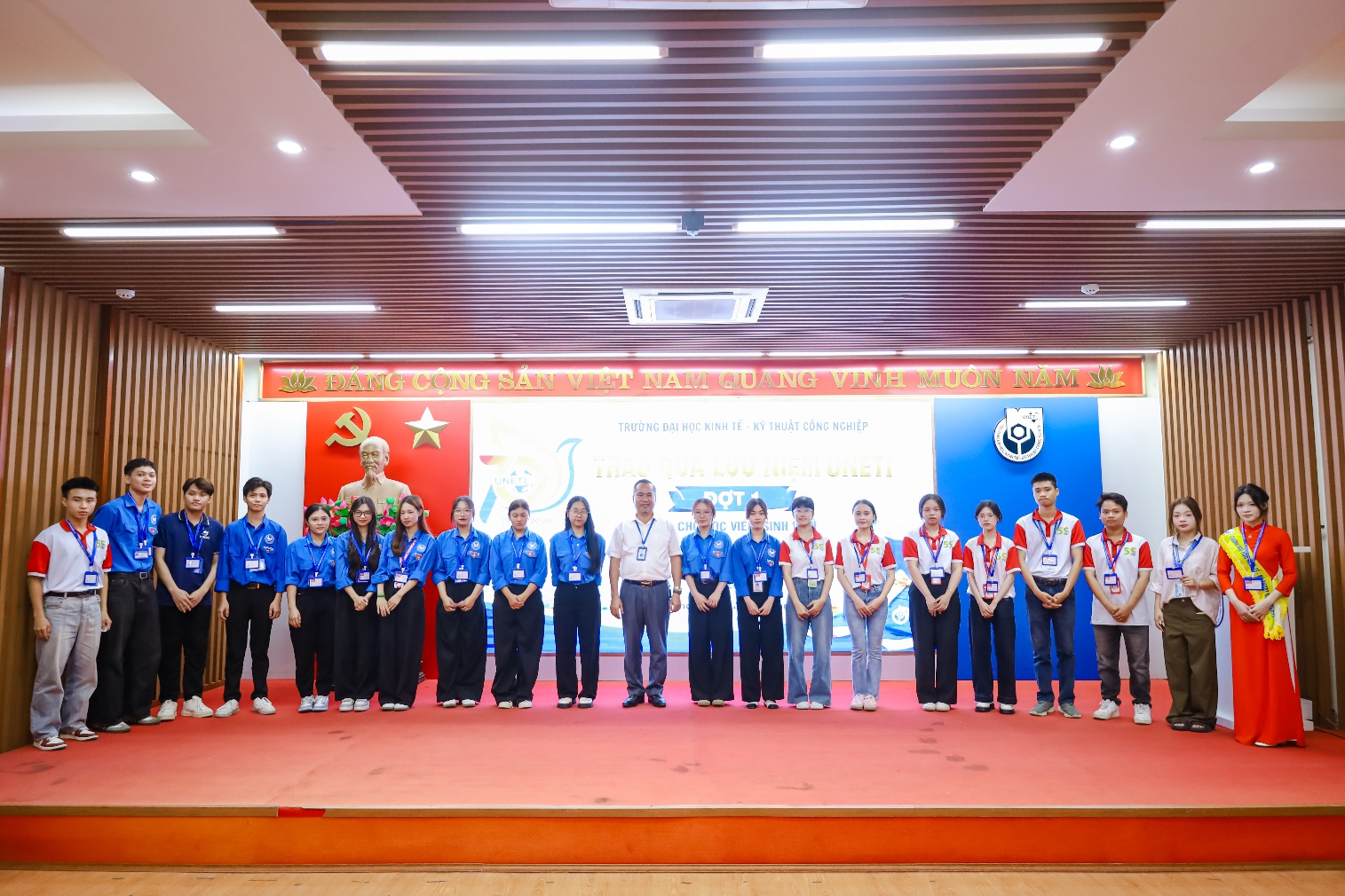 A group of people standing on a stage
Description automatically generated