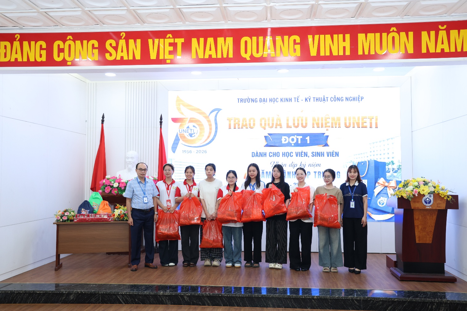 A group of people standing on a stage
Description automatically generated
