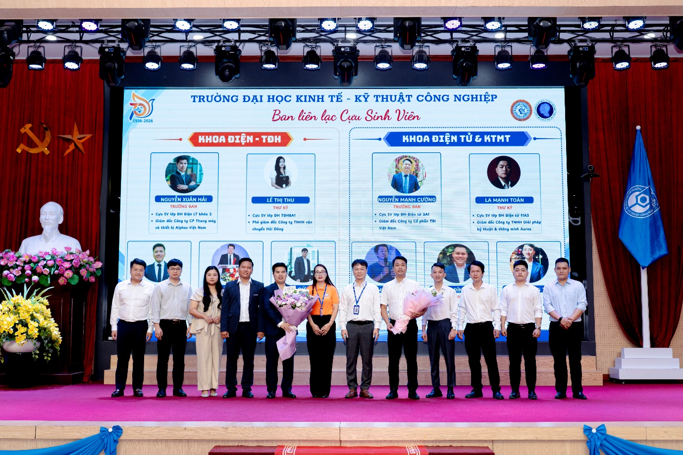 A group of people standing on a stage

Description automatically generated