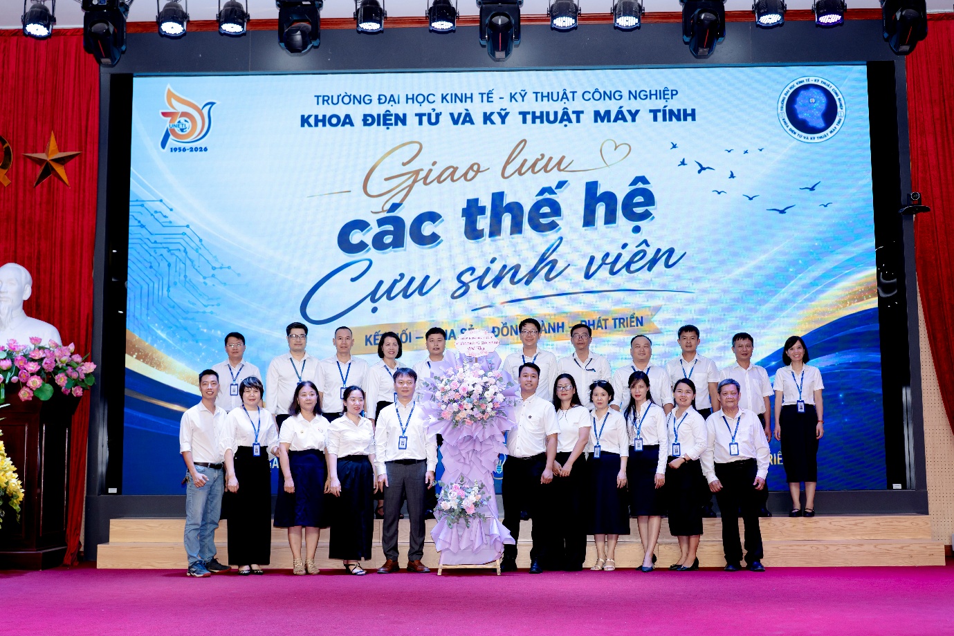 A group of people standing on a stage

Description automatically generated