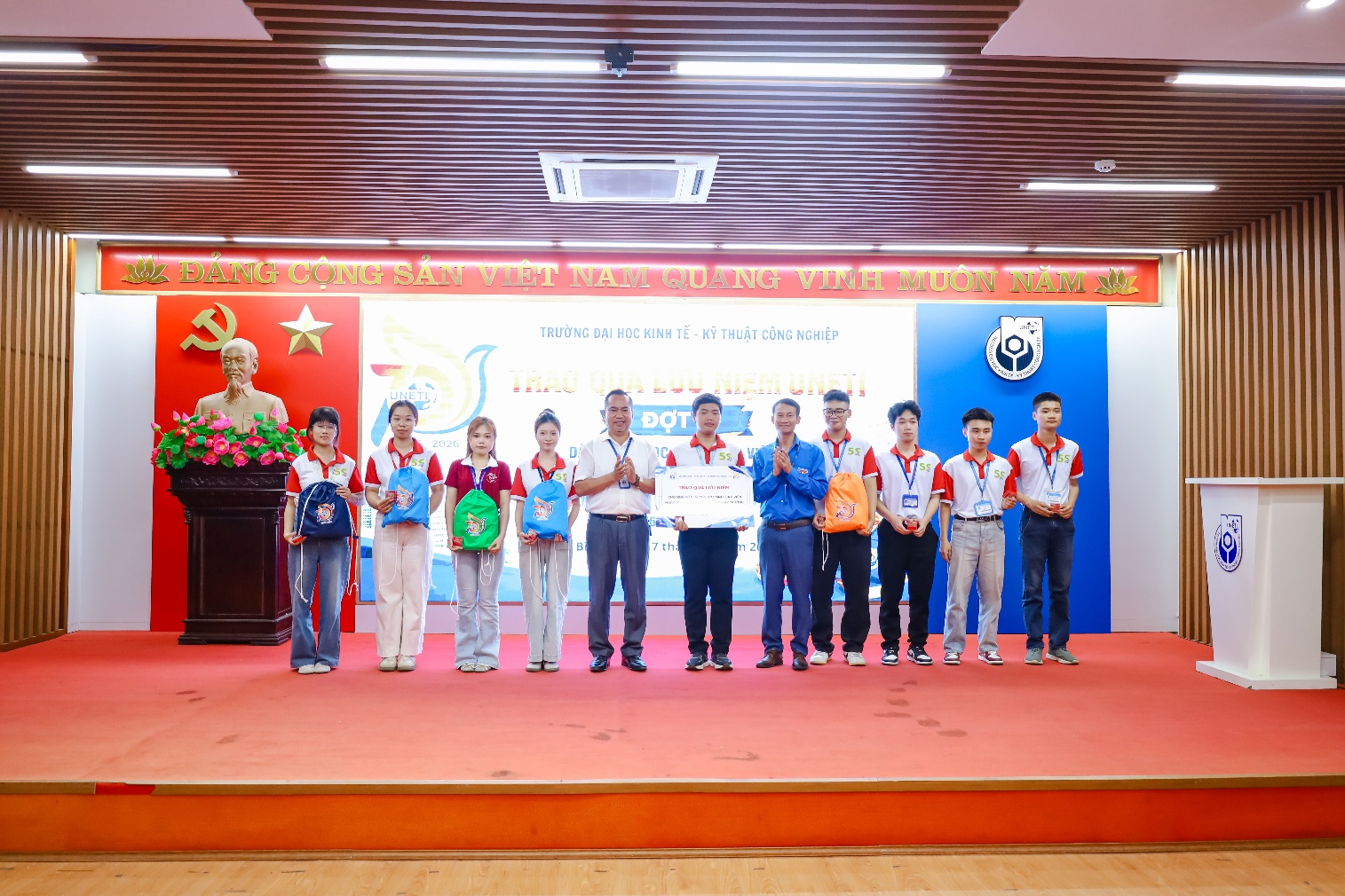 A group of people standing on a stage
Description automatically generated